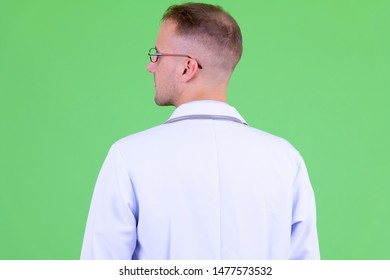 Closeup Rear View Of Man Doctor With Eyeglasses Looking Over Shoulder