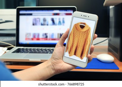 Close-up Rear View Of Woman Shopping Online For Buy Clothes From Cellphone Or Computer Notebook. Sale And Buy Product On E-Commerce Pay By Website Or Internet Banking Concept.