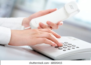 Close-up Of Receptionist Making A Phone Call