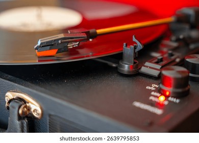 Close-up of record player needle tracking vinyl grooves during playback. Analog sound detail capturing retro music atmosphere. High quality photo