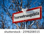 Close-Up of a Rectangular White Sign with Red Border and German Text 