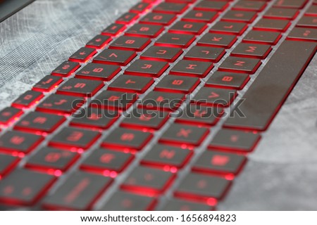 Close-up of red backlit keyboard with gray on hp laptop star wars edition