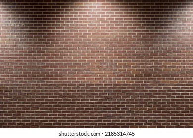 Closeup of red brick wall lit by outdoor spotlights at night. - Shutterstock ID 2185314745