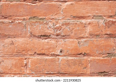 Close-up Of A Red Brick Wall Painted With Red Paint