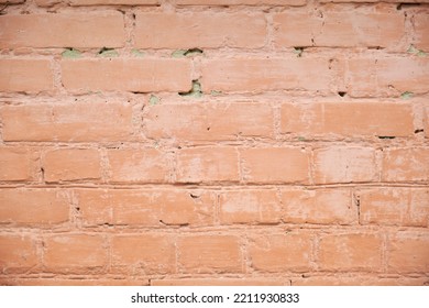 Close-up Of A Red Brick Wall Painted With Red Paint