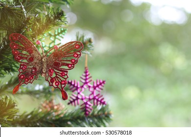 Closeup red butterfly decorated on Christmas tree 