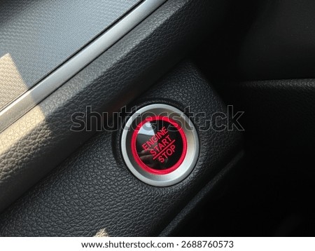 Close-up of a red button inside a car interior 