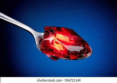 Close-up of red fruit jelly in spoon