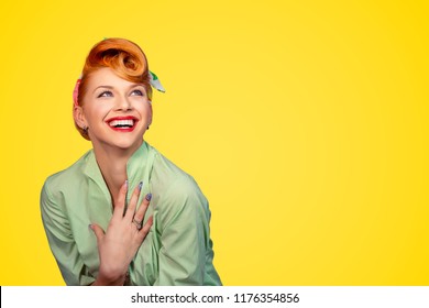 Closeup red head young excited woman pretty pinup girl green button shirt smiling laughing looking up isolated on yellow background retro vintage 50's style. Human emotions body language positive face