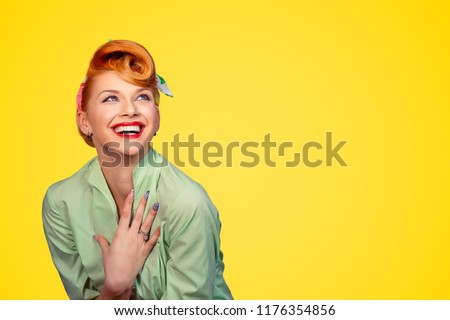Closeup red head young excited woman pretty pinup girl green button shirt smiling laughing looking up isolated on yellow background retro vintage 50's style. Human emotions body language positive face