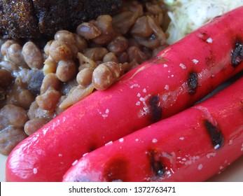 A Close-up Of Red Hot Dogs On A Plate Of Maine Style Franks And Beans 