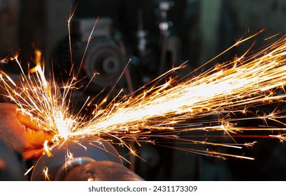 Close-up red hot sparks at grinding steel material.  - Powered by Shutterstock