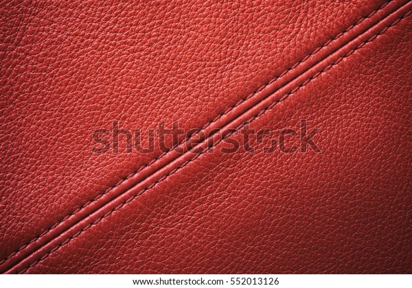 Closeup red\
leather with sewing seam for\
background