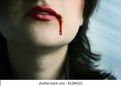 Closeup of Red lips of a young girl, with blood flowing by.