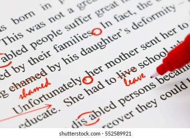 closeup red marks on proofreading english document - Shutterstock ID 552589921