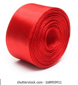 Closeup Of Red Ribbon Roll Over White Background