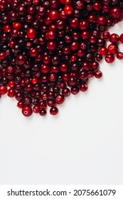 Close-up Of A Red Ripe Cranberry On A White Background. Berry As An Ingredient And Source Of Vitamins, Healthy Food. Top View, Copy Space