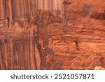 Close-up of red rock cliff face with natural patterns and erosion