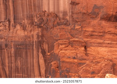 Close-up of red rock cliff face with natural patterns and erosion - Powered by Shutterstock