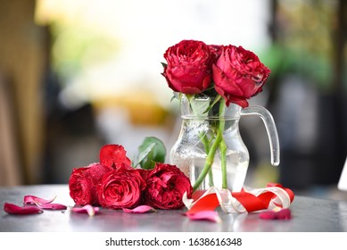 closeup red roses Heart thorp in glass vase , red and gold ribbon on grey table sweet love on valentine's day blur back ground - Powered by Shutterstock