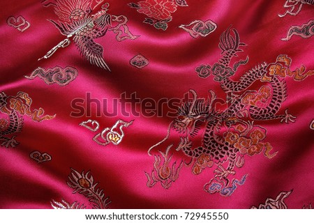 Closeup of a red silky chinese fabric with oriental motifs