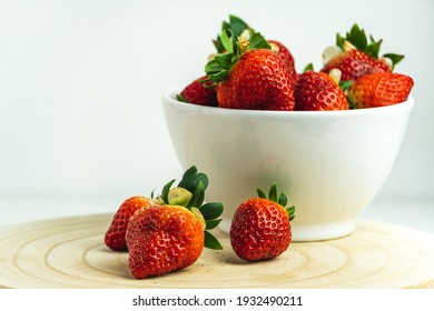 Close-up Of Red Strawberries In A White Bowl And On A Wooden Board.