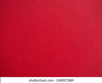 Close-up of the red wavy plastic surface texture for background and wallpaper.