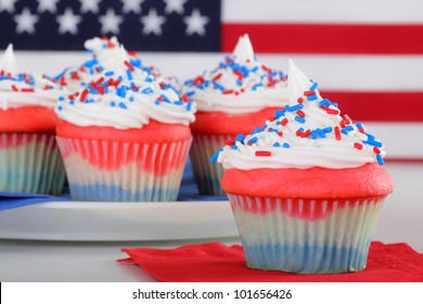 Closeup Of Red White And Blue Cupcake With Cupcakes And Flag In Background