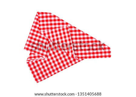 Closeup of a red and white checkered napkin or tablecloth isolated on white background. Kitchen accessories.