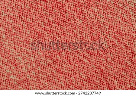 Close-Up of Red and White Patterned Fabric Featuring Repetitive Geometric Design