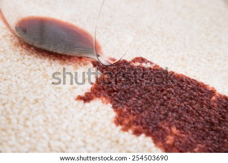 Close-up Of Red Wine Spilled From Glass On Carpet