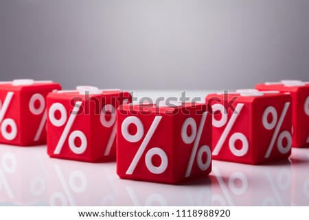 Close-up Of Red Wooden Blocks With Percentage Symbol On Reflective Background