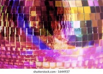 close-up of a reflective mirrorball with differnet colours shining