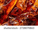 Close-up of Refreshing Cola with Ice Cubes Background,Top view close-up of dark brown cola or soda with sparkling ice cubes. High angle macro shot of refreshing cold beverage with bubbles and liquid.