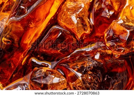 Close-up of Refreshing Cola with Ice Cubes Background,Top view close-up of dark brown cola or soda with sparkling ice cubes. High angle macro shot of refreshing cold beverage with bubbles and liquid.