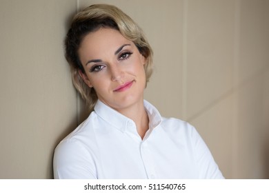 Closeup Of Relaxed Content Woman Leaning On Wall