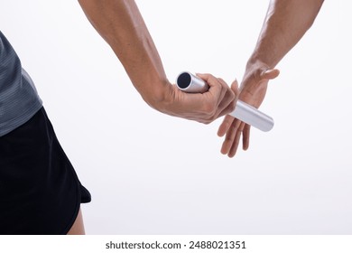 Close-up of a relay race with athletes passing the baton on a white background, with copy space. Precision and teamwork are essential in this moment of the track event. - Powered by Shutterstock