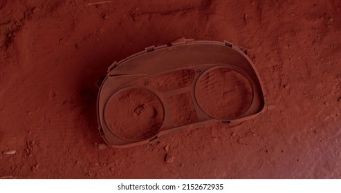 A Close-up Of The Remains Of A Spectacle Frame Lies On The Ground In Red Dust. Lost Item At The Factory. Glasses Are Missing.