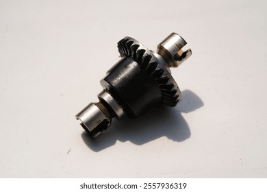 Closeup Remote Control Car Differential Gear isolated on white. Metal Gear parts allowing the wheels to turn at different speeds while receiving power from the motors. Toy Parts. Hobbies and leisures. - Powered by Shutterstock