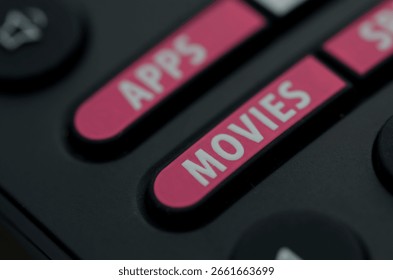 Close-Up of Remote Control Featuring Pink APPS and MOVIES Buttons