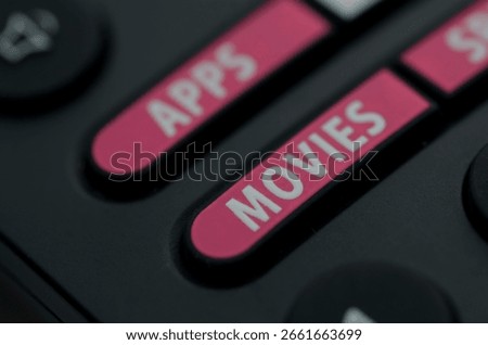 Close-Up of Remote Control Featuring Pink APPS and MOVIES Buttons