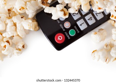 Close-up Of Remote Control And Popcorn Over White Background