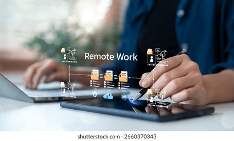 Close-up of remote working using laptop and tablet with file sharing icons and team connection, illustrating online collaboration and digital workflow.