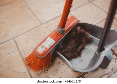 Close-up remove the cut hair with a scoop and a broom in the hairdresser's - Shutterstock ID 764628178