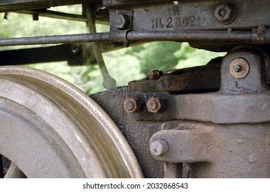 Closeup Up Of A Restored Vintage Steam Train Axle Mechanism With Rusty Train Wheel