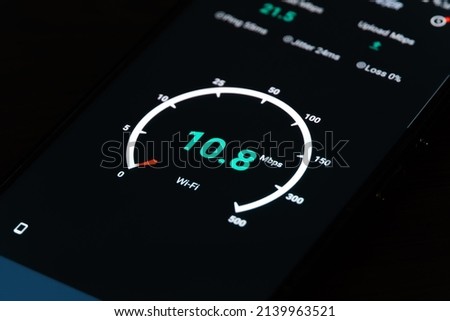 Close-up of the result of checking the Internet speed on a mobile phone on a black background