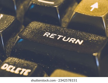 A closeup of a 'return' button on a computer keyboard