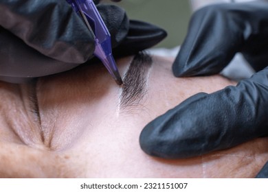 close-up reveals the precision of the microblading needle, delicately crafting each hair stroke. Witness the transformation of sparse brows into fuller. microblading or eyebrow tattooing