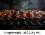 Close-up of ribs smoking on a grill.