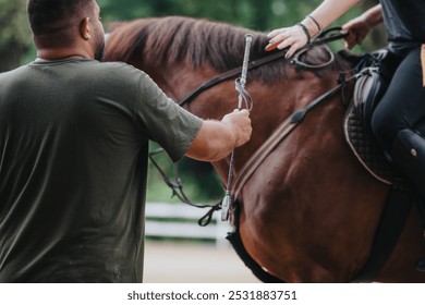Close-up of a rider receiving instruction while horseback riding outdoors at a ranch, highlighting the bond and interaction with the horse.